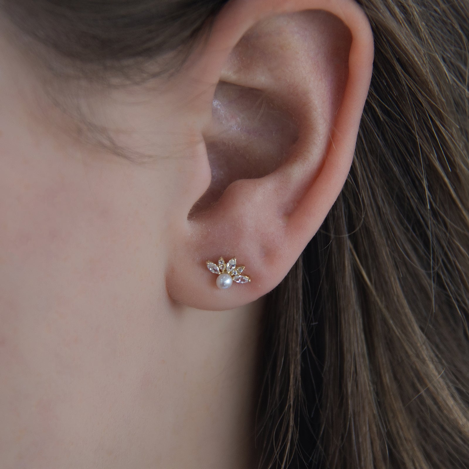 9ct gold pearl and crystal stud earrings on a model 
