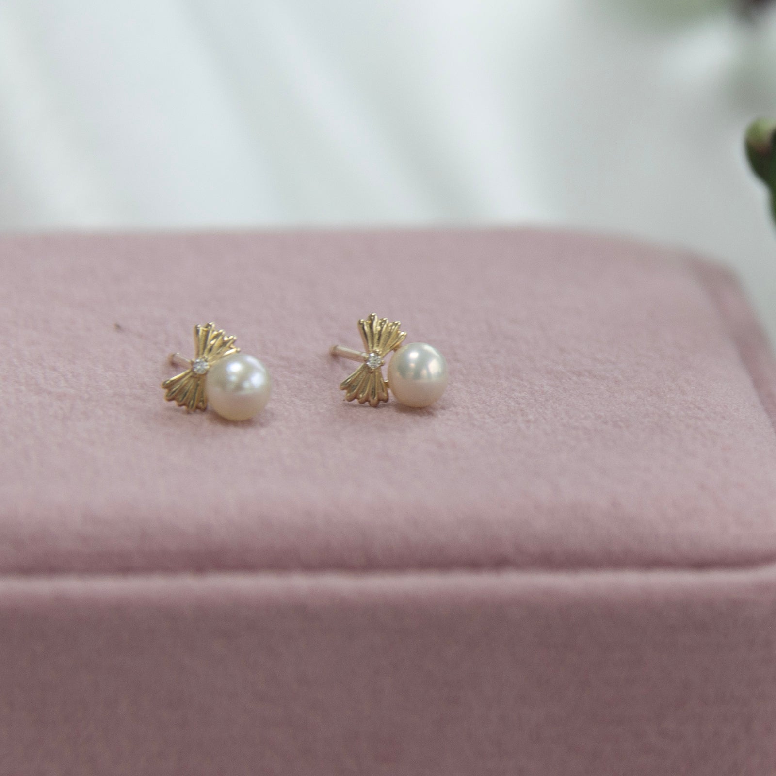 9ct gold pearl studs with bow on a their pink velvet gift box 