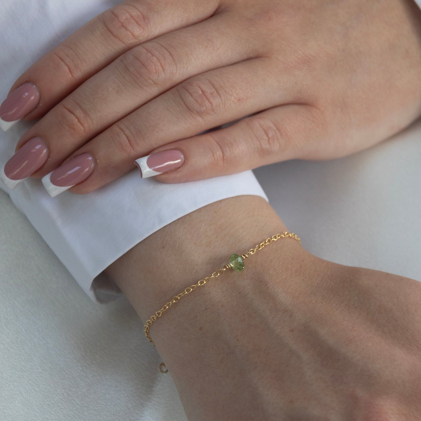 august birthstone bracelet gold on a model 