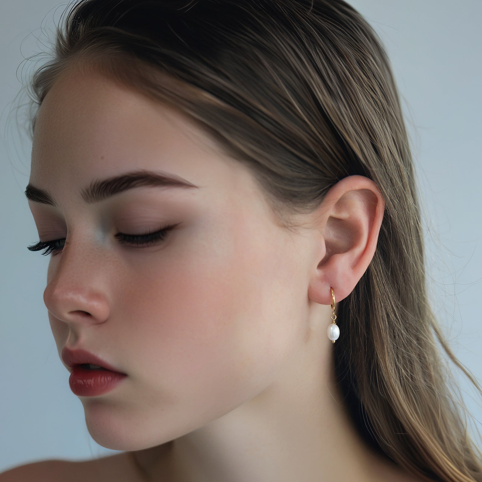 freshwater pearl hoop earrings on a model 