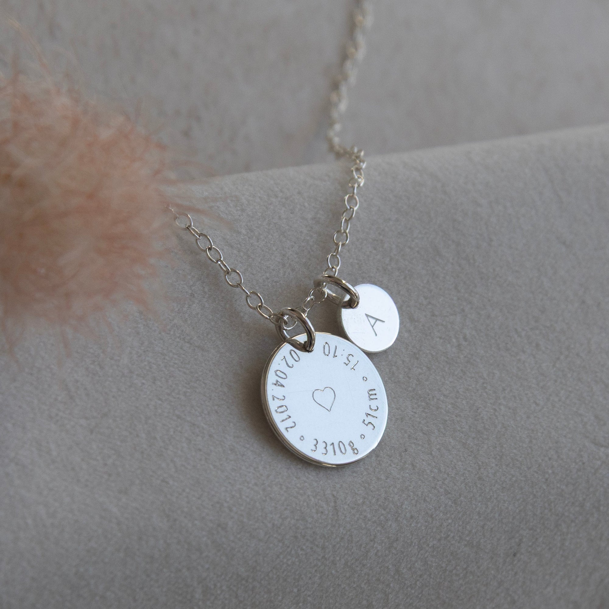 Sterling silver Birthcoin necklace with baby’s initial and birth details engraved – sentimental personalised gift for new parents.