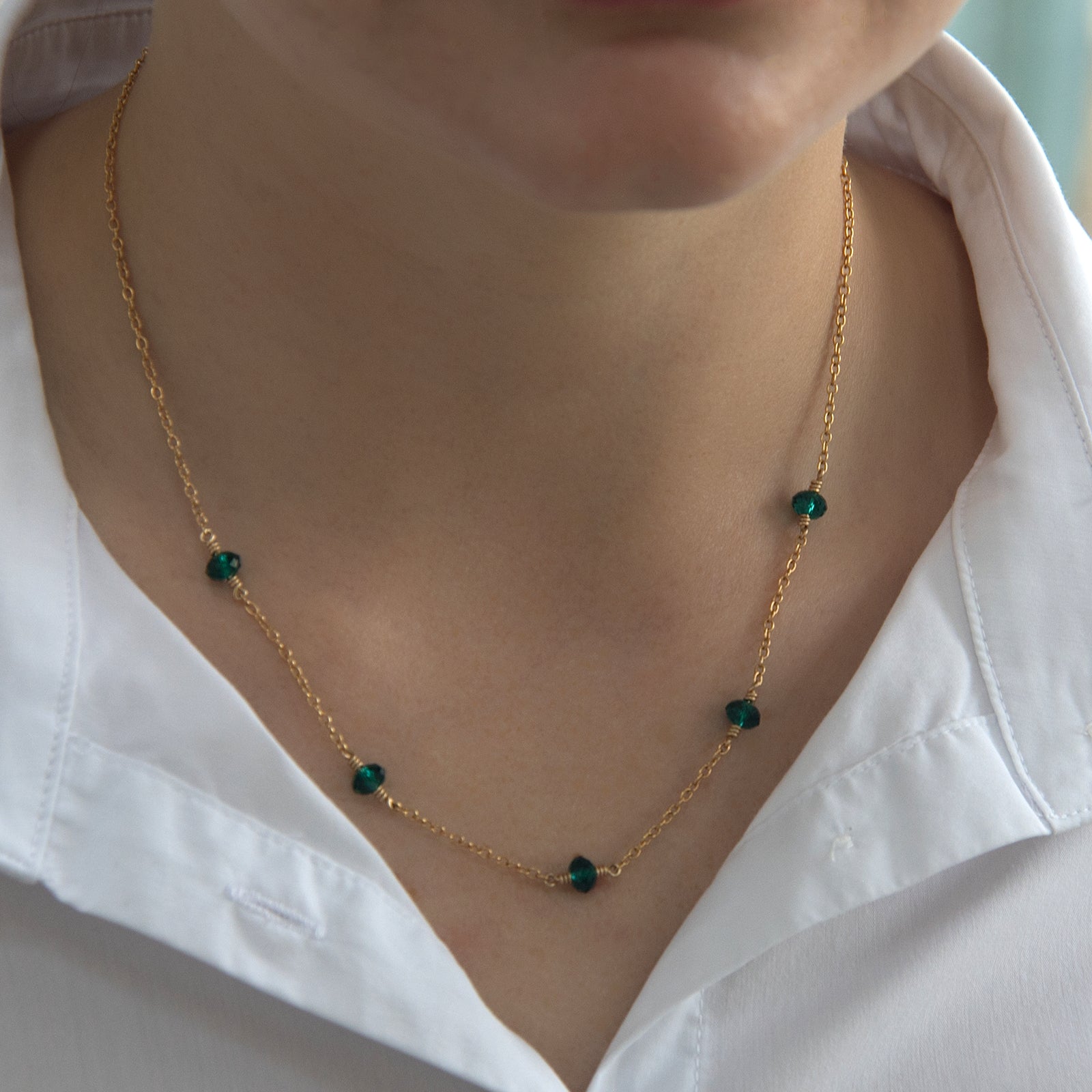family birthstone necklace with five birthstones on a models necklace 