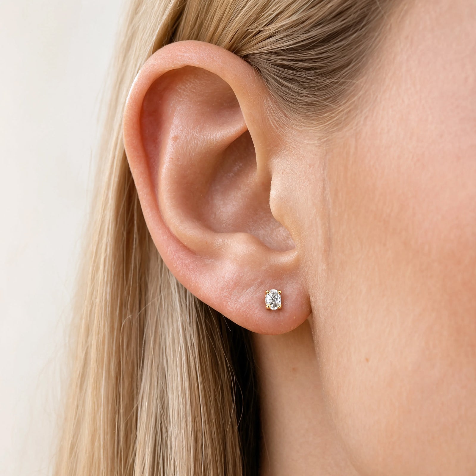 April birthstone earrings in a models ear crystal quartz 