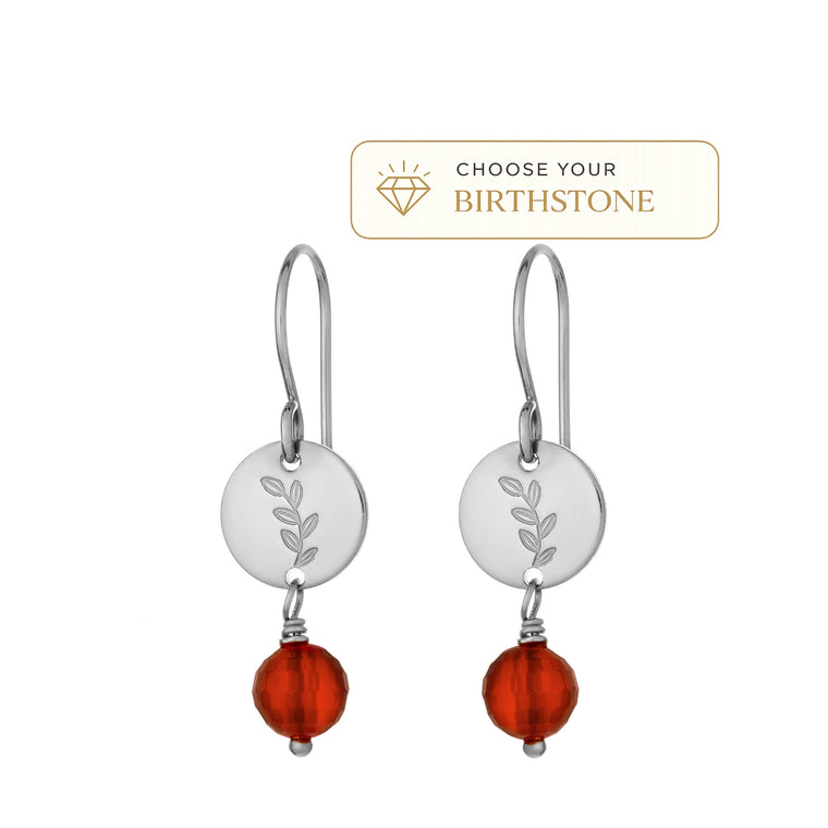 A pair of silver drop earrings with engraved leaf-shaped discs and carnelian birthstone for July for shown on a white background with a 'Choose Your Birthstone' label attached. 