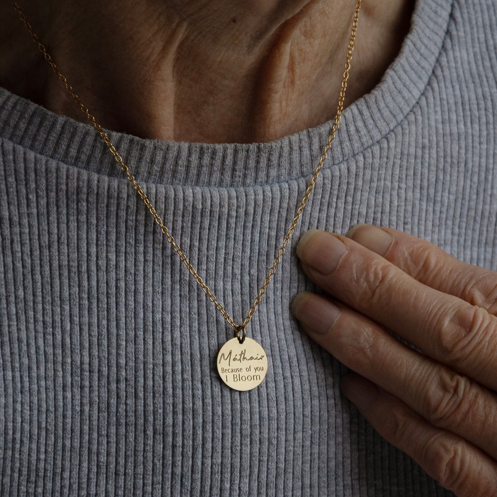 Back view of the Máthair Bloom Necklace worn on an older woman to show the size and scale of the pendant.