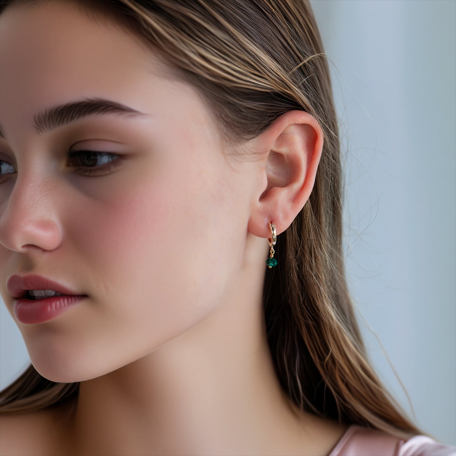 may birthstone hoop earring gold on a model 