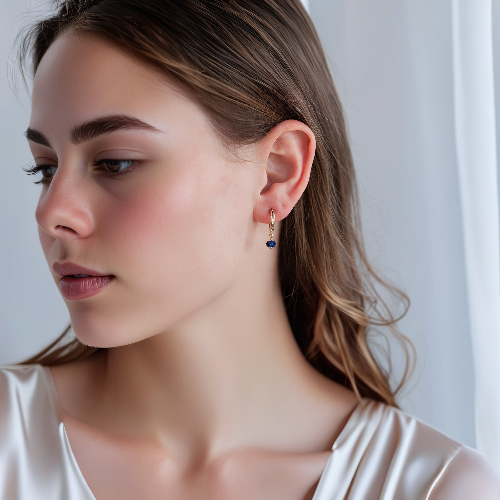 september birthstone hoop earrings gold on a model full face 