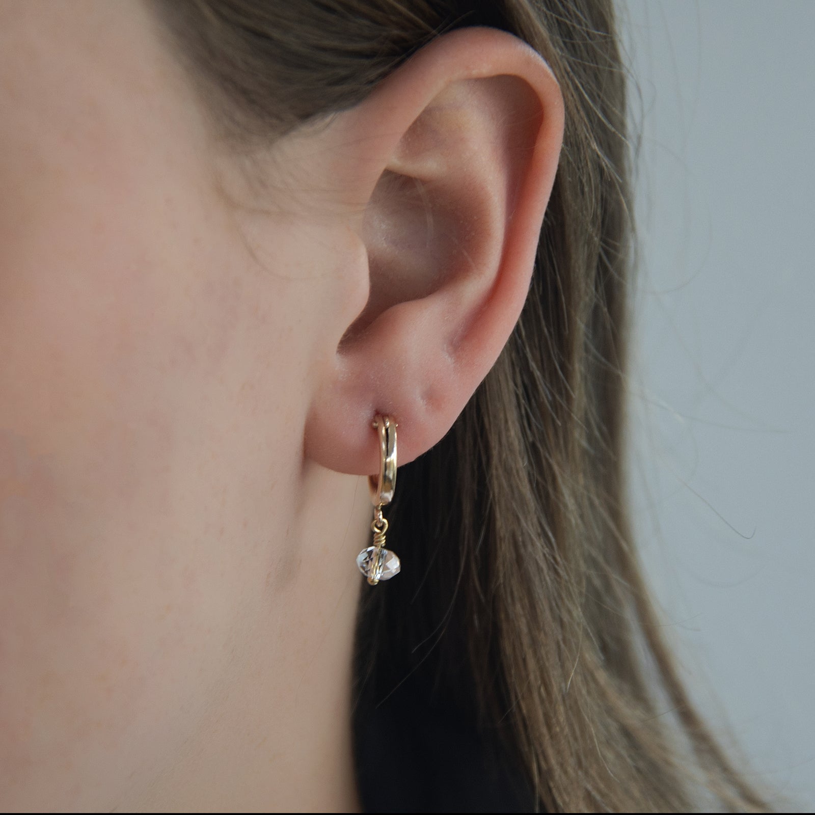 april birthstone earrings on a model close up 