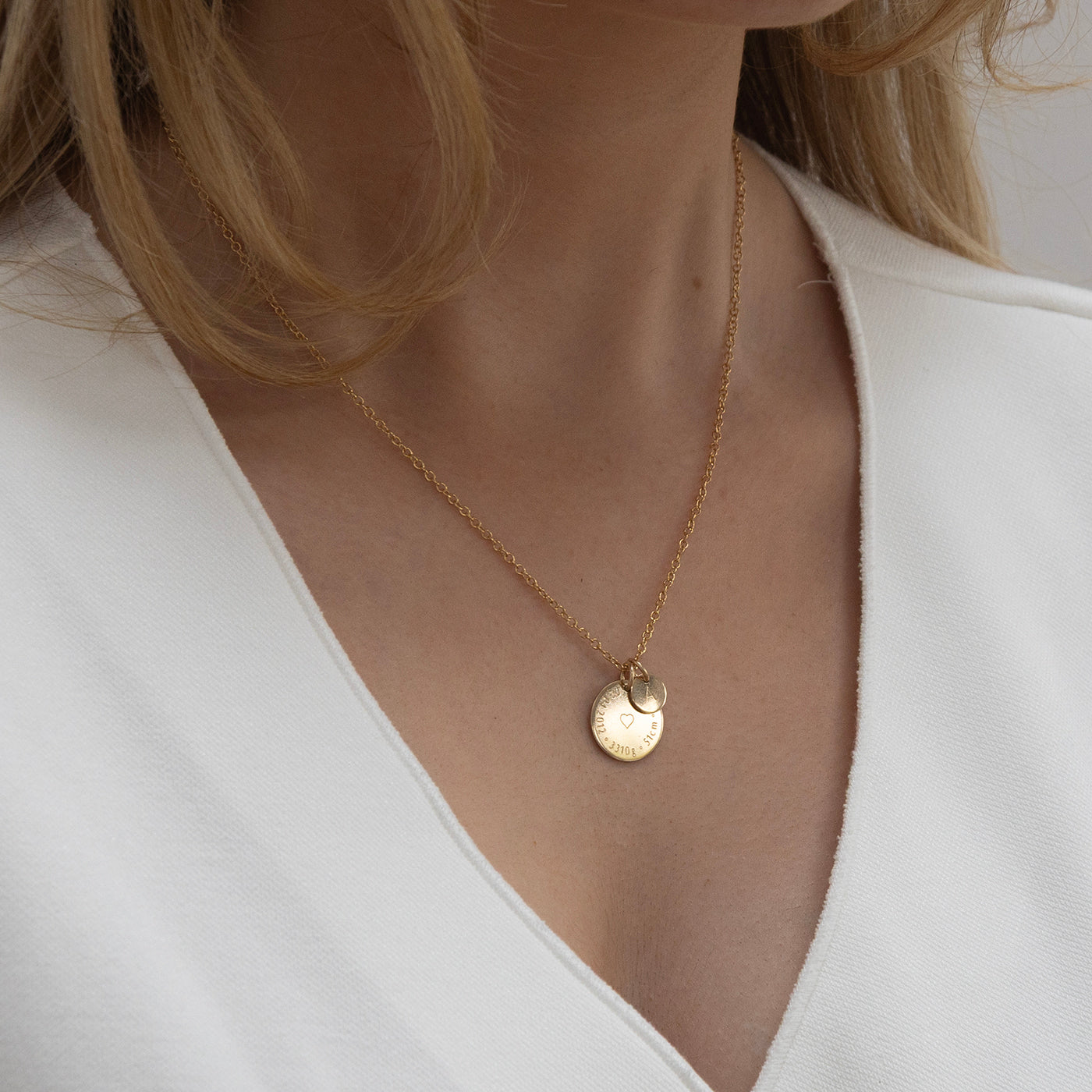 New mom wearing Birthcoin engraved birth details necklace – sentimental personalised jewellery gift to celebrate baby’s arrival.