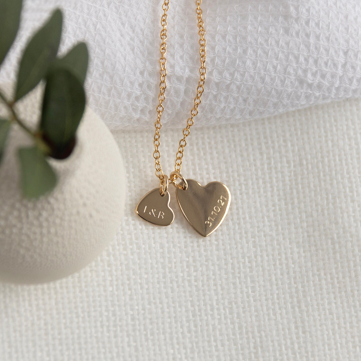 engraved gold double heart necklace with initial and date 