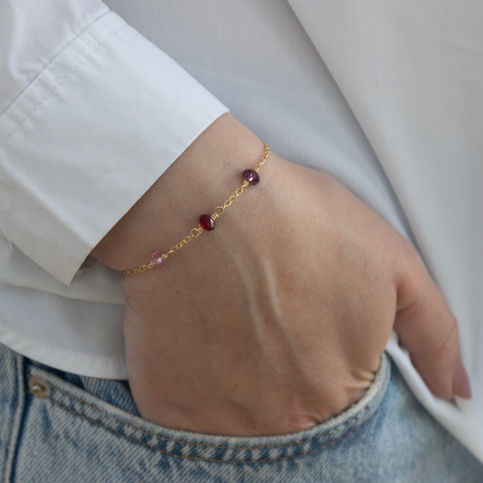 family birthstone bracelet with three birthstones worn by a model 
