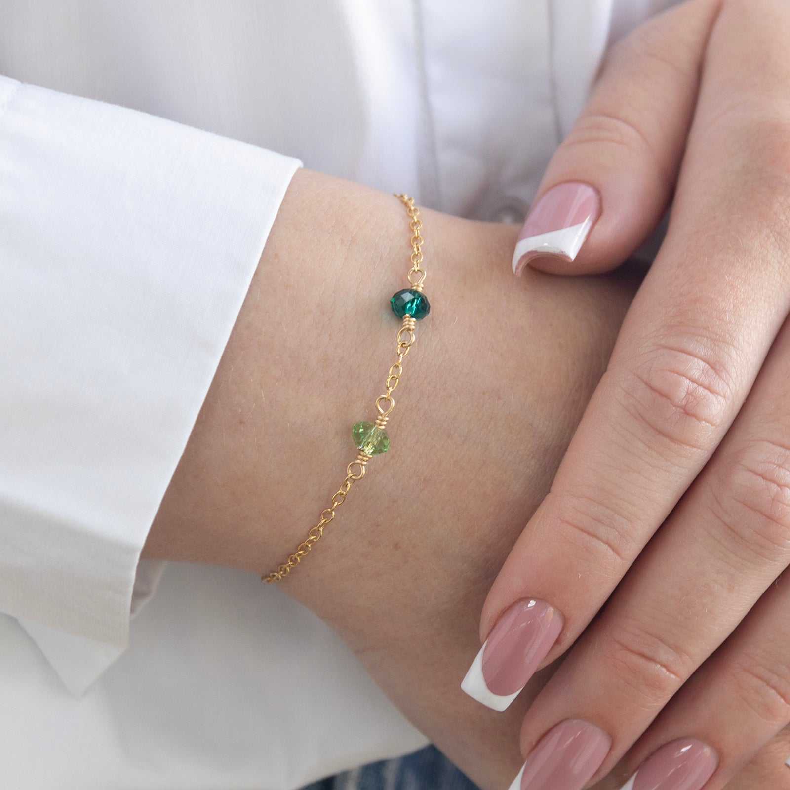 family birthstone bracelet two stones gold on a model 