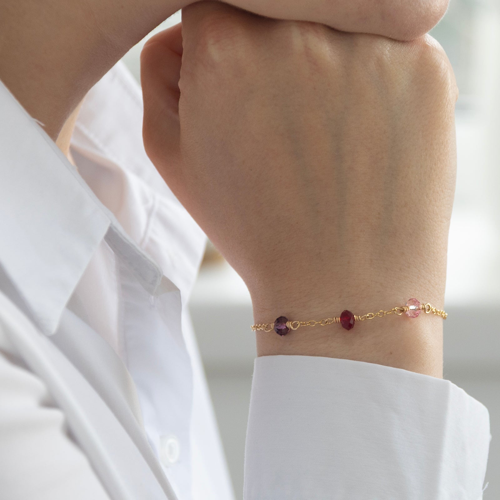 family birthstone bracelet with three birthstones on a model in gold 
