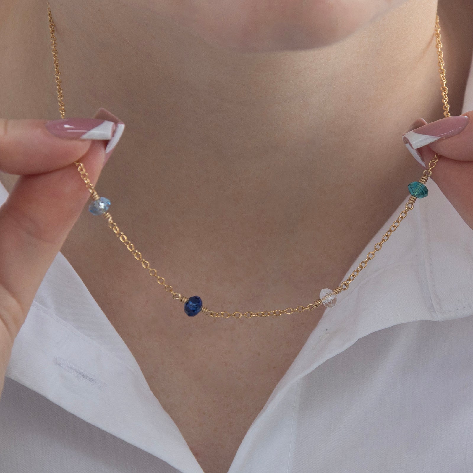 family birthstone necklace with four birthstones on a model 