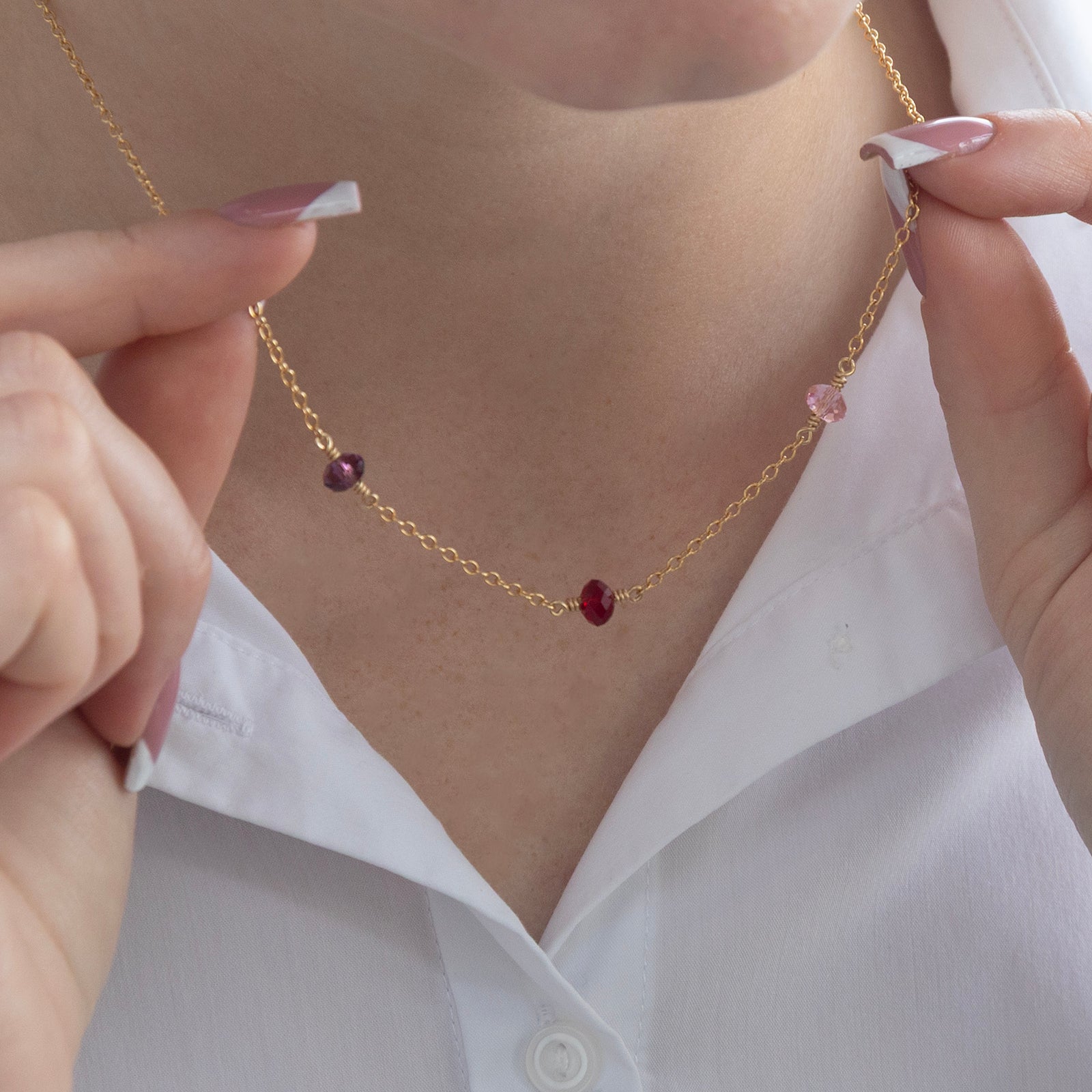 family birthstone necklace gold with three birthstones on a model 