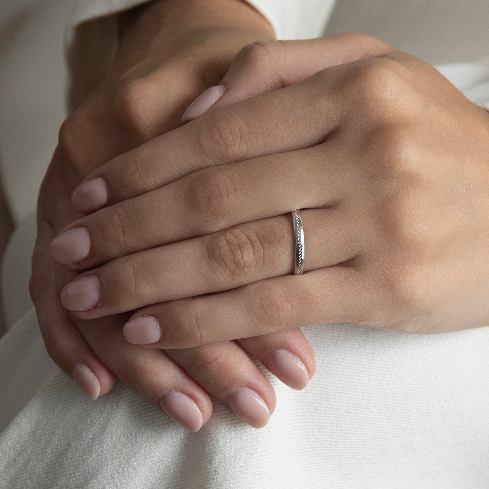 first light wedding ring on a model white suit 