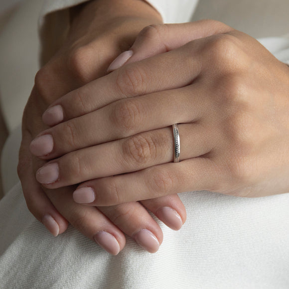 The First Light wedding ring in yellow gold, a slender 2.5mm ring with fine pearlised grooves running around it