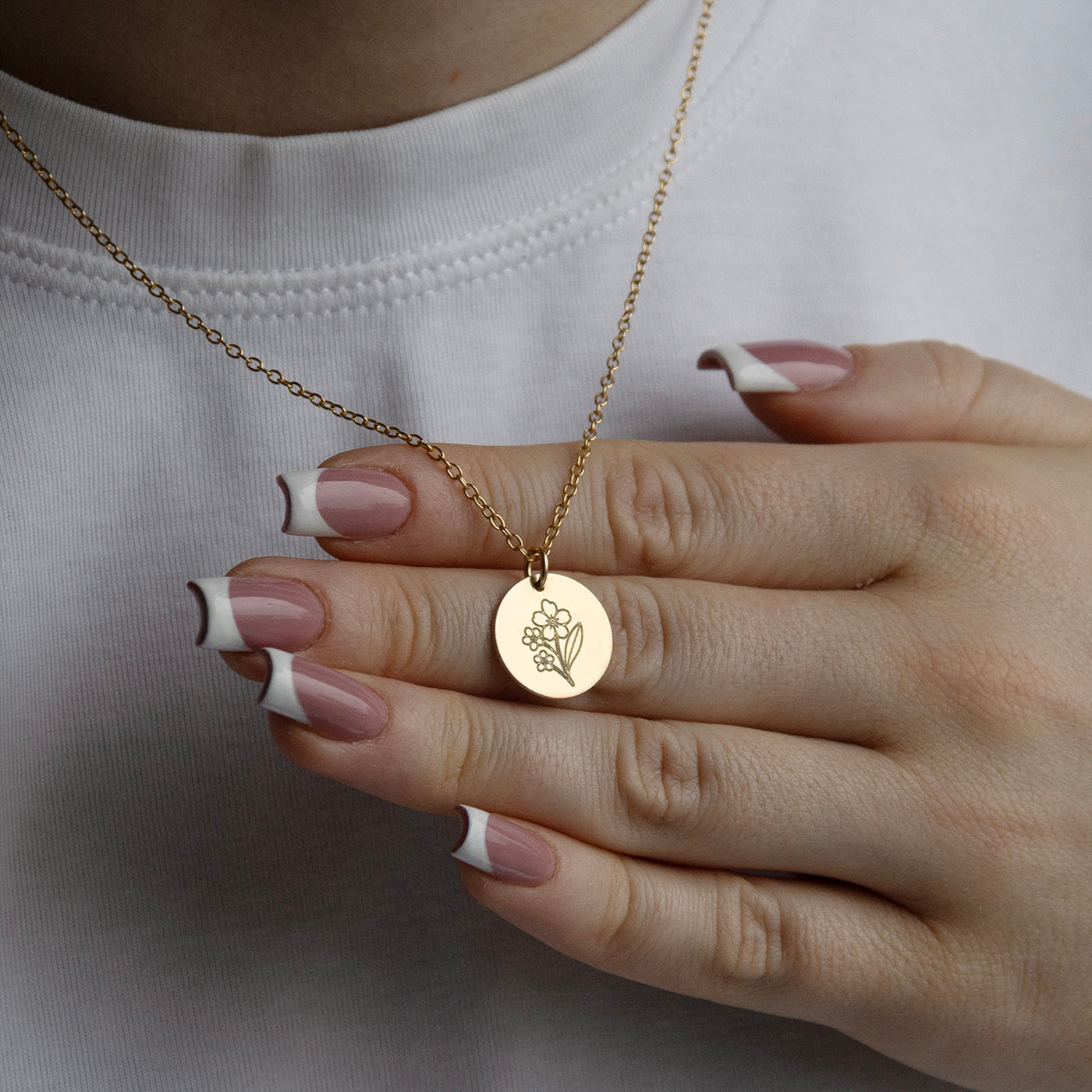 lifestyle image of forget me not memorial necklace from the front on a model 