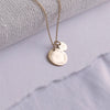 Close-up of Birthcoin necklace engraved with baby’s birth date, time, weight and height – custom birth keepsake necklace.