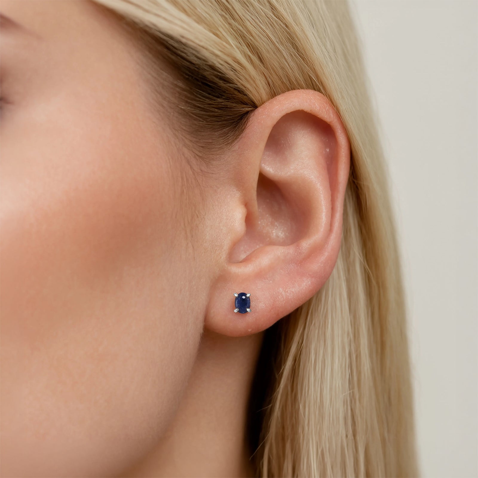 silver lapis lazuli birthstone stud in a models ear 