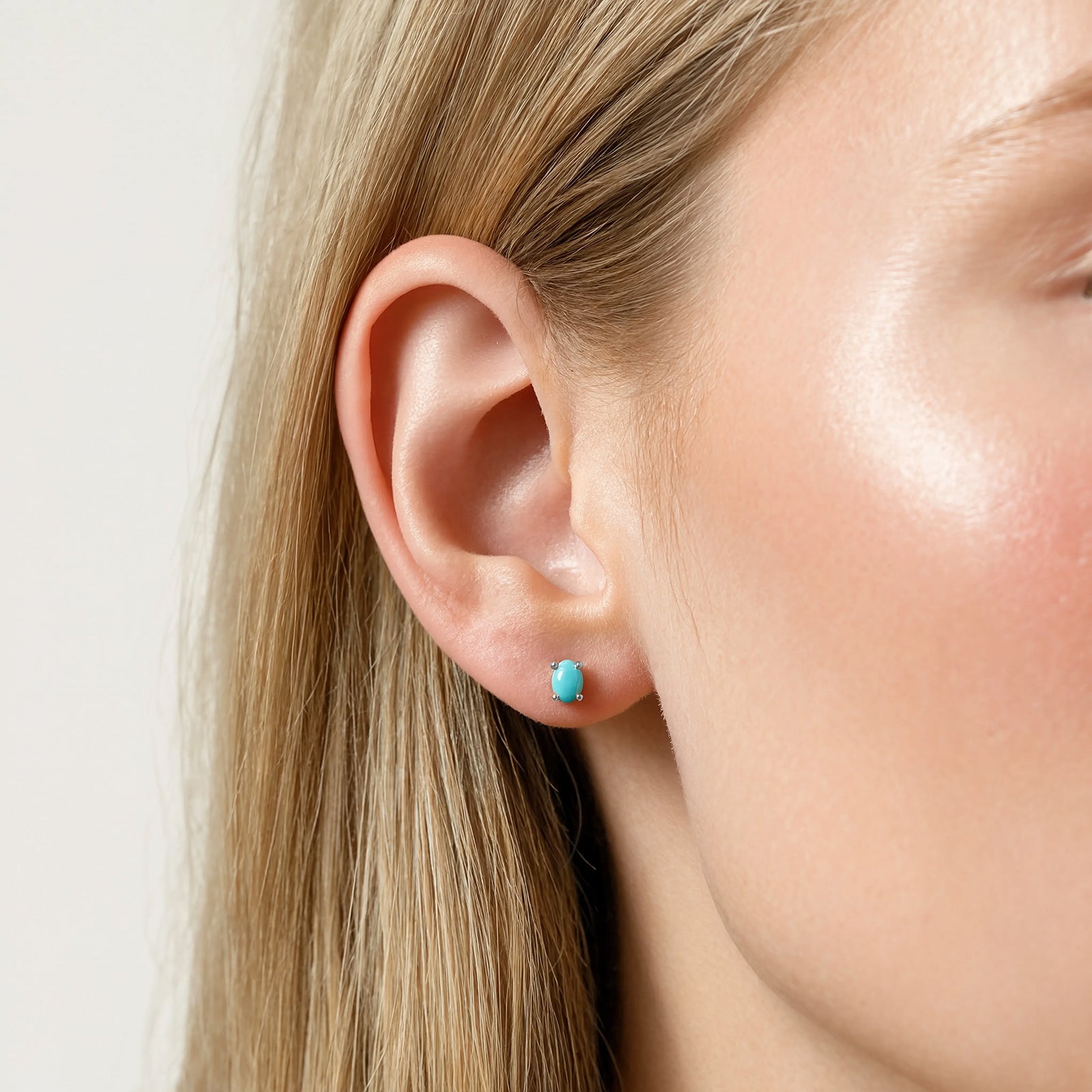 silver turquoise birthstone stud in a models ear 