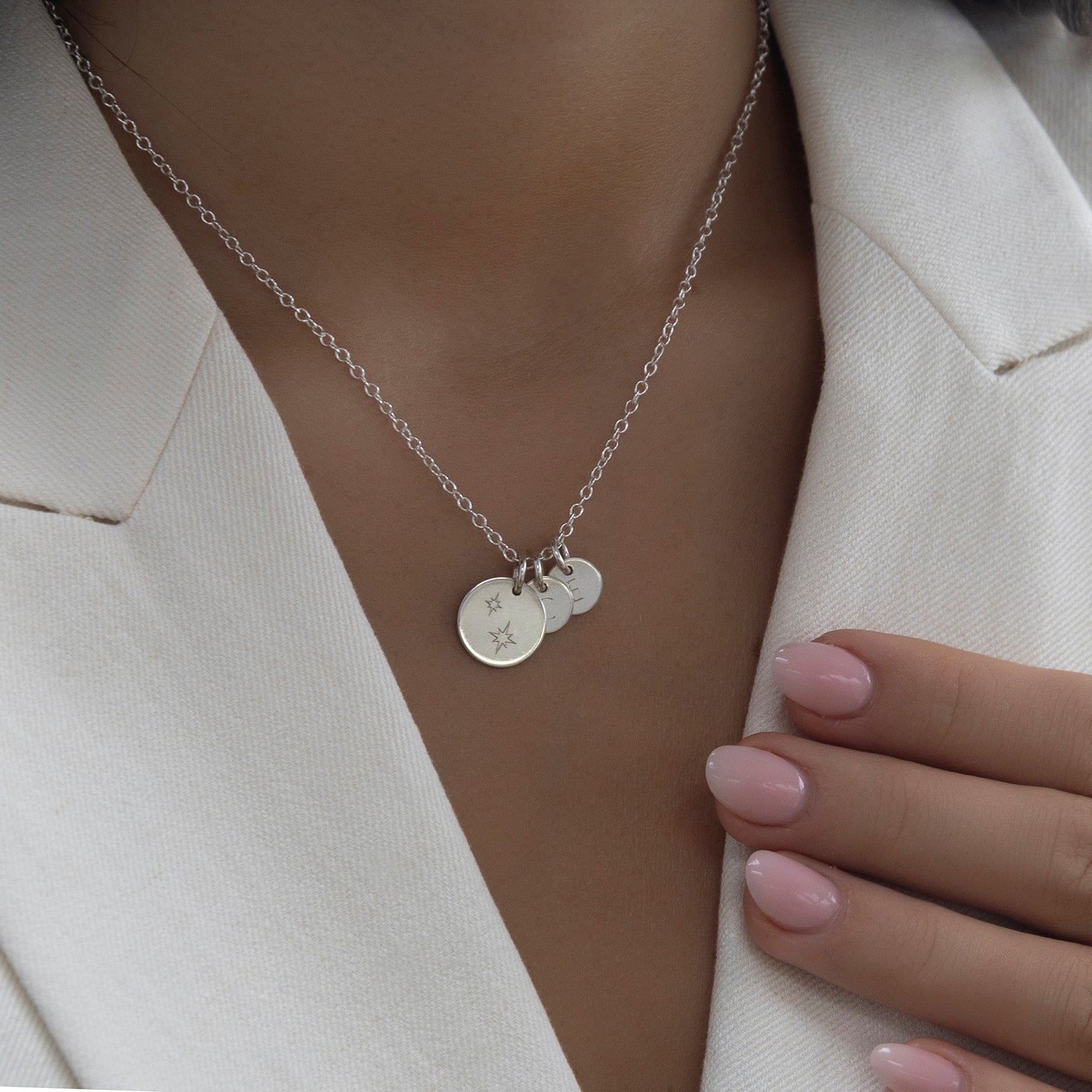 silver star family necklace on a model 