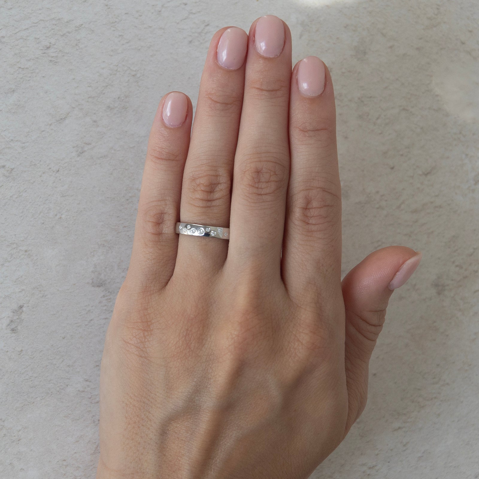 the night sky diamond wedding ring on a model 