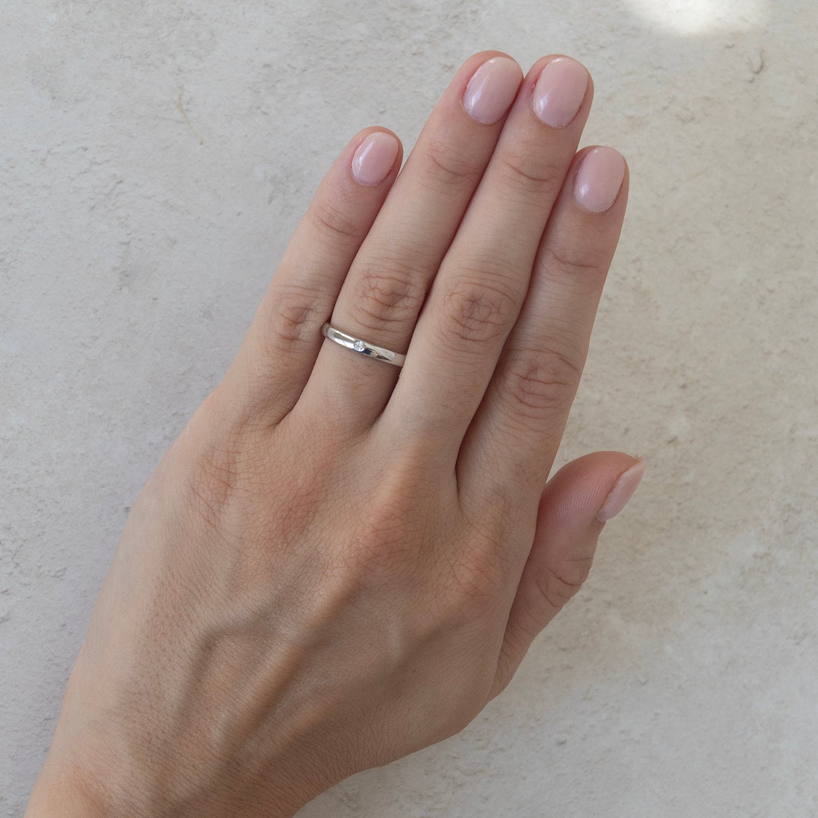 the one diamond wedding ring on a model 