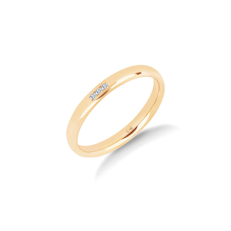 The Three Wishes wedding ring in yellow gold, a polished 2.5mm women's ring with three channel set diamonds