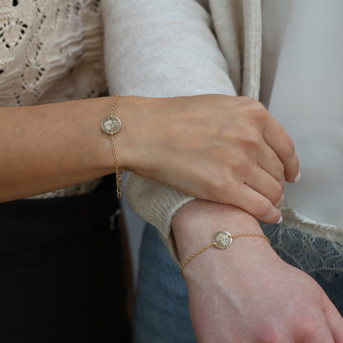 Two friends wearing matching Wild Bunch bracelets