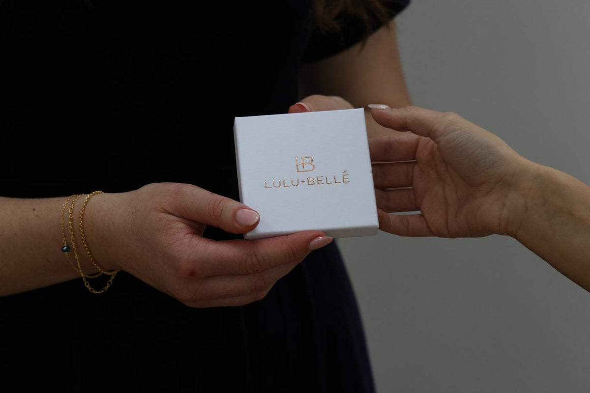A Lulu + Belle gift box being handed over